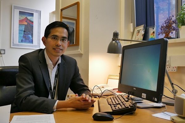 Dr. Boon Lim, consultant cardiologist sitting at his office desk