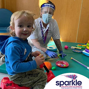 Sabine Maguire MBE, Sparkle, toddler on a play mat