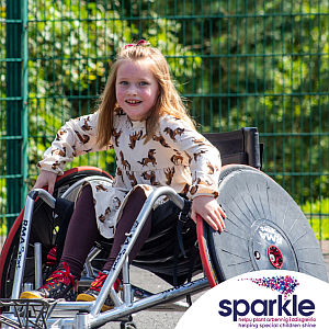 Sabine Maguire MBE, Sparkle, smiling girl in a wheelchair