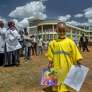 Toby Tanser, CEO/Founder of Shoe4Africa - young boy wearing oversized yellow t shirt